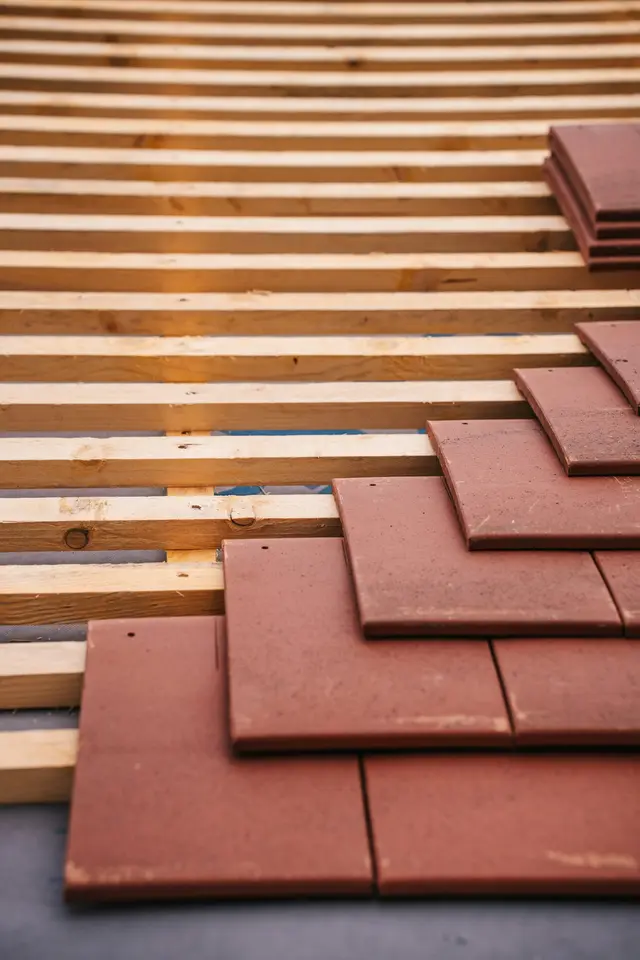 Roof tiles being installed on a pitched roof