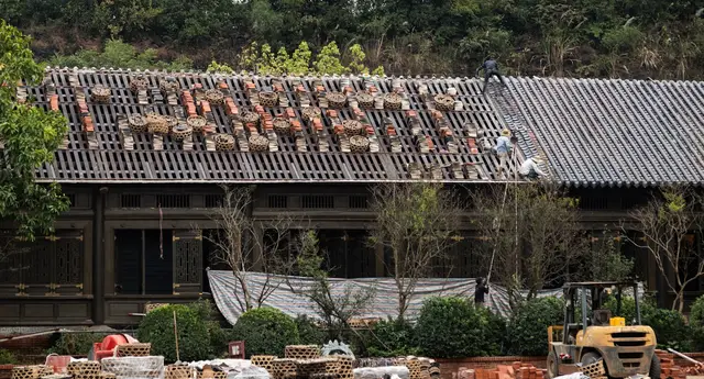 Roofer repairing storm-damaged tiles