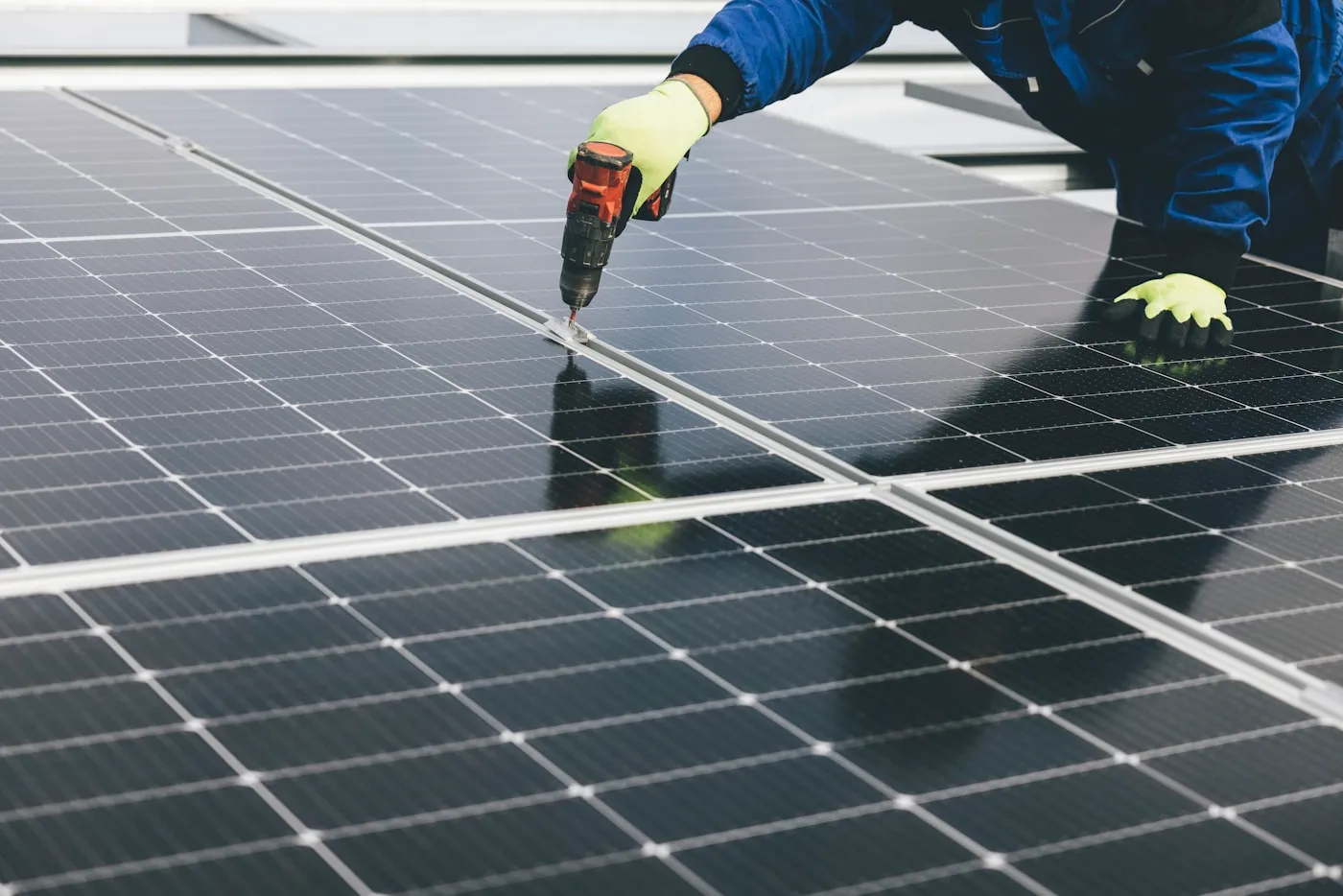 Solar installer fitting panels on a residential roof