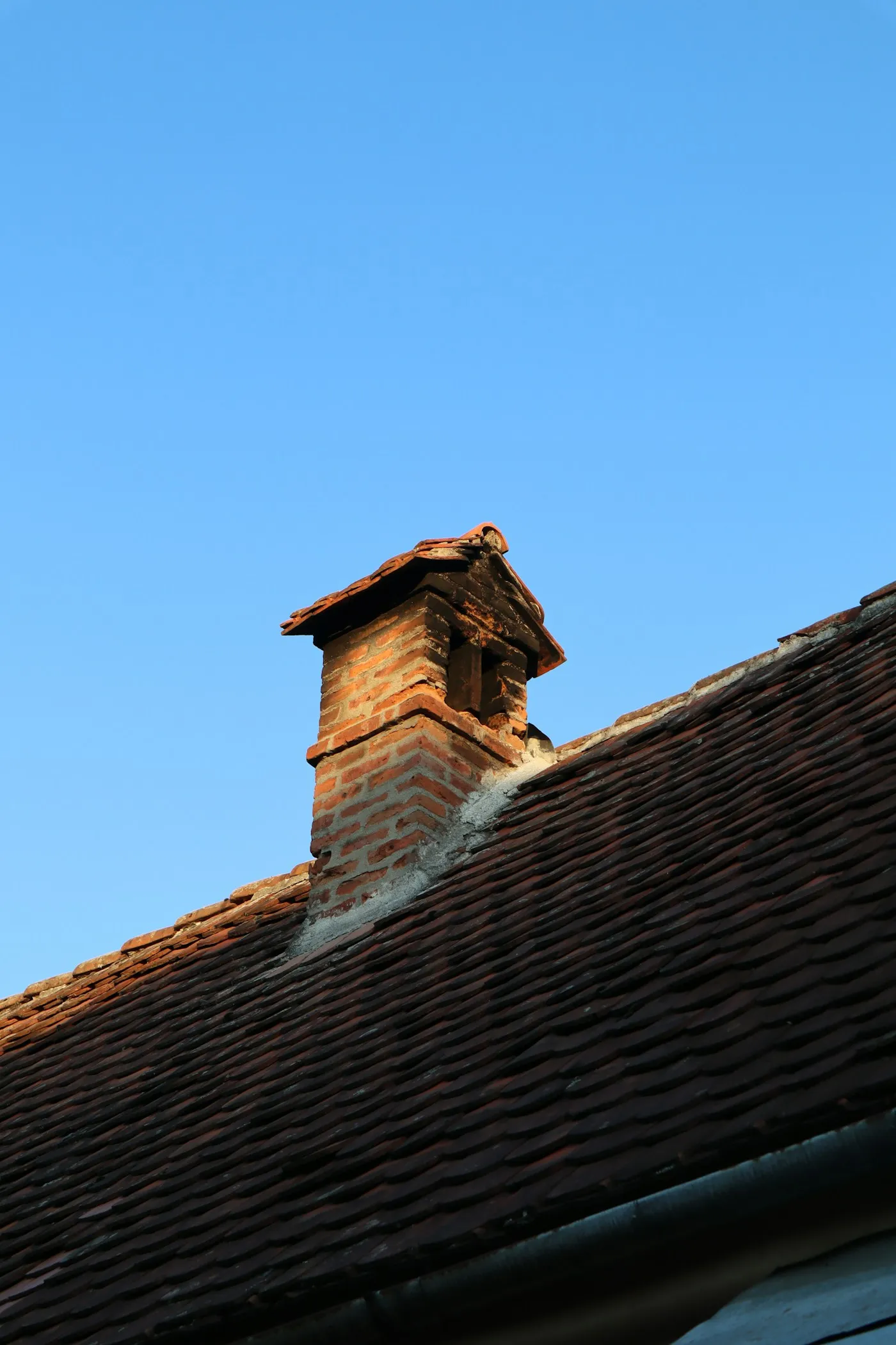 Brick chimney stack on a residential roof
